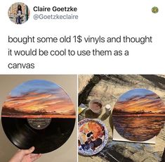 someone is holding up a record that has been painted with sunsets and clouds on it