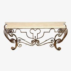 an iron and marble console table with hearts on the top, against a white background