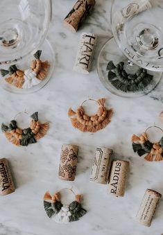 wine corks are arranged on a marble counter top next to wine glasses and other items