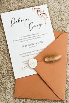 an envelope with a button on it and a card attached to the inside of it