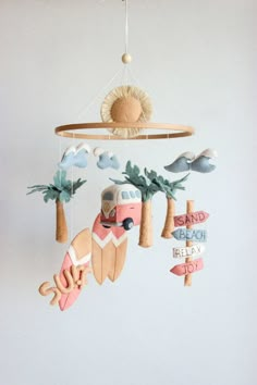 a mobile that is hanging from the ceiling with surfboards and palm trees on it