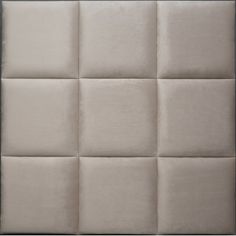 an upholstered headboard with square squares on the top and bottom, in beige linen