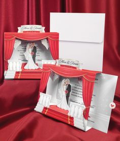 two red and white wedding cards with a bride and groom on the stage in front