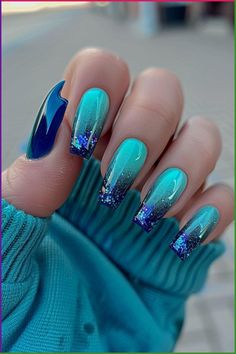 Whether you’re a seasoned nail artist or a beginner, these cute and simple heart designs are a creative way to add love to your look. Blue And Sparkle Nails, Aura Acrylic Nails, Blue And Green Nails Designs, Blue Gradient Nails, Blue And Green Nails, Ombre Glitter Nails, Aura Nail, Ombre Acrylic, Blue Glitter Nails