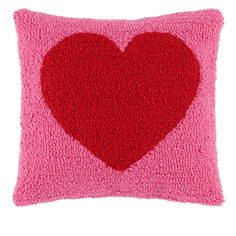 a pink pillow with a red heart on it