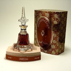 the perfume bottle is on display in front of an open box with it's contents