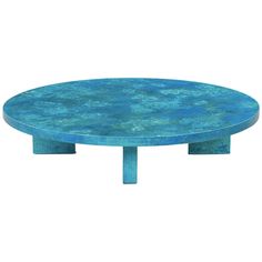 a round blue table sitting on top of a white floor