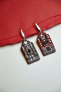 Dancing houses, inspired by the beautiful architecture along Damrak canal, in Amsterdam.  DETAILS -Polymer clay in different shades, main colors Black and Burgundy.  -All backings are surgical stainless steel which makes each earring hypoallergenic. Due to the handmade nature of each item, expect slight variations. PROCESSING TIME Processing time before shipping your order will be around  7-10 business days , since this item is individually handmade-to-order. If you need it by a specific date, p Landscape Earrings, Dancing House, Small Jewelry Box, Earrings Polymer Clay, Earrings Statement, Travel Jewelry, Modern Earrings, Beautiful Architecture, Small Jewelry