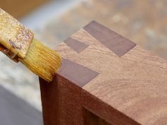 a wooden block with a paintbrush sticking out of it