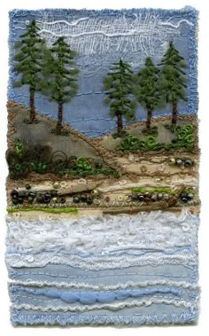 a piece of fabric with trees and water on it's side, in the middle of