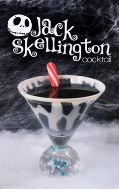 a black and white drink with a candy cane in it