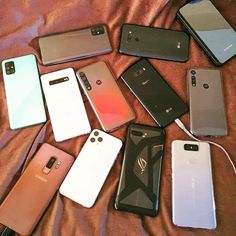 many different cell phones are laying on a bed