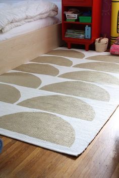 a child's bedroom with a bed, bookshelf and rug on the floor