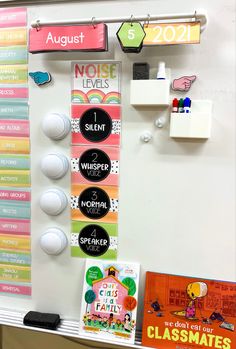 a bulletin board with magnets, books and other school supplies on it's side