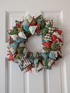 a wreath made out of fabric on the front door to look like a christmas wreath