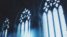 the sun shines through two large windows in an old building with stained glass panels