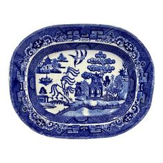 a blue and white platter with an image of a castle in the distance on it