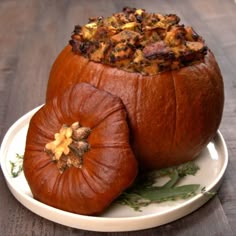 two pumpkins are sitting on a plate