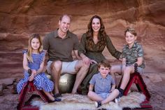 a family poses for a photo in front of a rock formation