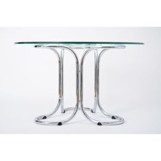 a round glass table with metal legs