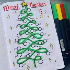 a christmas tree drawn on a notebook with markers