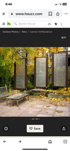 a screen shot of a bench in the middle of an outdoor area with yellow leaves on the ground