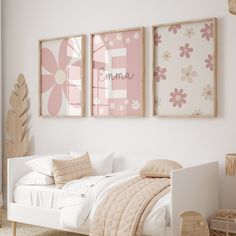 a bedroom with pink and white decor on the walls, including a small bed in front of two framed pictures