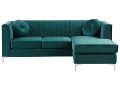 a green couch with pillows and a footstool