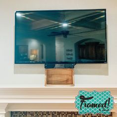 a flat screen tv mounted above a fireplace