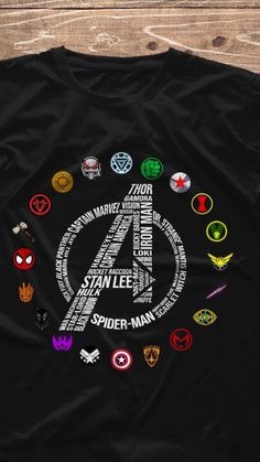 the avengers logo surrounded by many different symbols on a black t - shirt with wood background