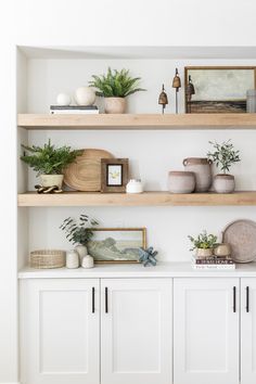 the shelves are filled with plants and other decorative items, including potted greenery