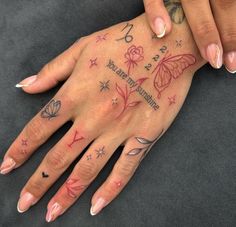 a woman's hand with tattoos on it