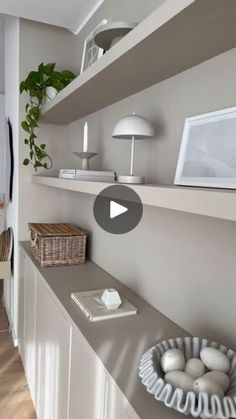 a living room with shelves filled with eggs and plants on top of it's shelf