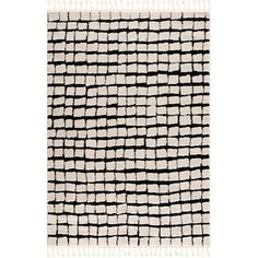 a black and white rug with small squares on the bottom, along with fringes