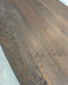 a close up of a wooden table with white paint on it and wood grains all over the surface