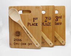 three wooden cutting boards with spoons and labels for the 2nd place, 3rd place and third place