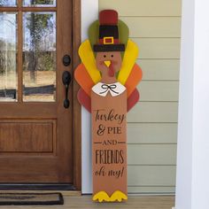 a turkey and pie sign on the front door of a house with a thanksgiving decoration