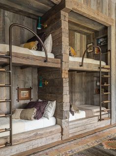 two bunk beds in a room with wooden walls