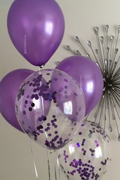 purple and white balloons with confetti on them