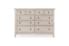 a white dresser with many drawers and knobs on the bottom drawer, against a white background