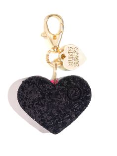 a black heart shaped keychain hanging from a gold tone metal hook on a white background