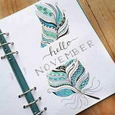 an open notebook with the words hello november written in cursive writing on it