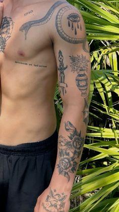 a man with tattoos on his arm and chest