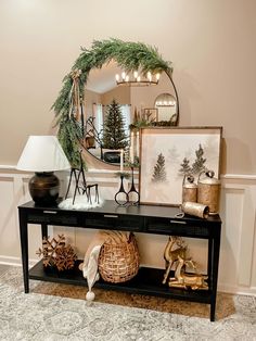 a black table topped with a mirror next to a shelf filled with christmas decorations and other items