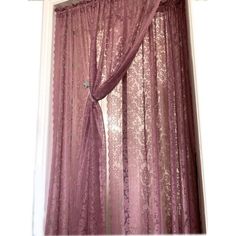 the curtain is open and ready to be hung in front of the window with lace on it