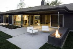 an outdoor patio with fire pit and seating area