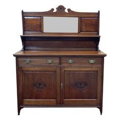 an old fashioned wooden dresser with mirror on top