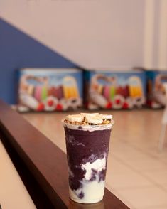 an ice cream sundae sitting on top of a wooden table