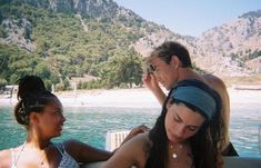 two women and a man on a boat in the water