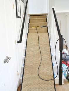 a carpeted stair tread with an electric charger plugged into the top and bottom